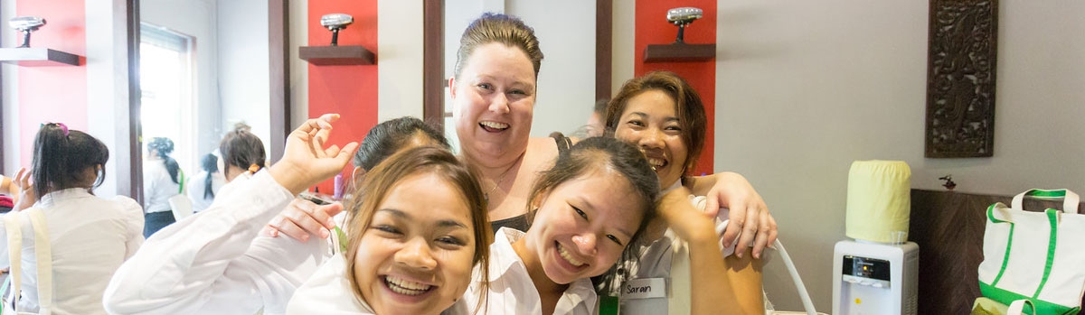 Beauty Plus educator and students smiling together
